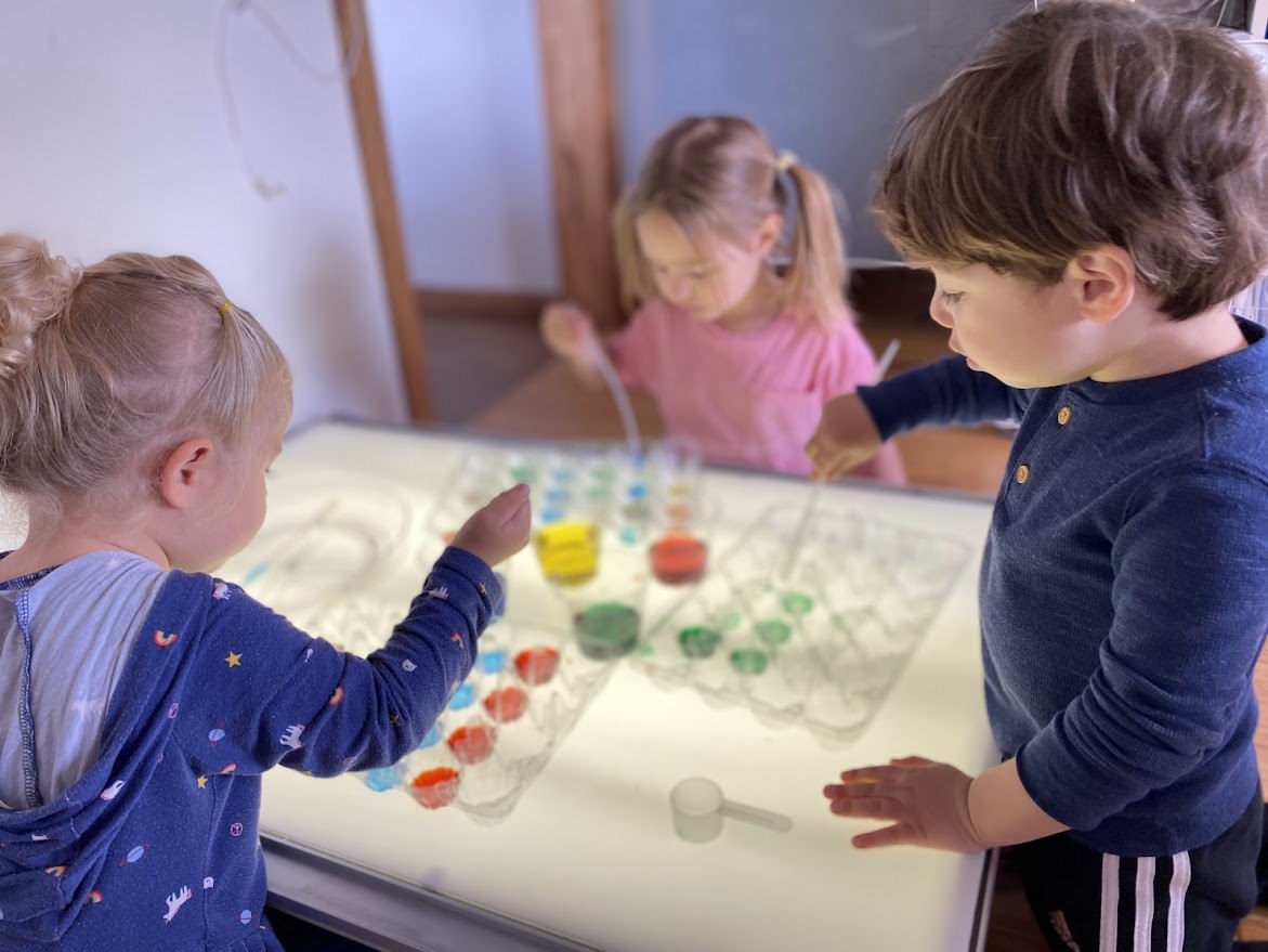 Children exploring a sensory activity indoors
