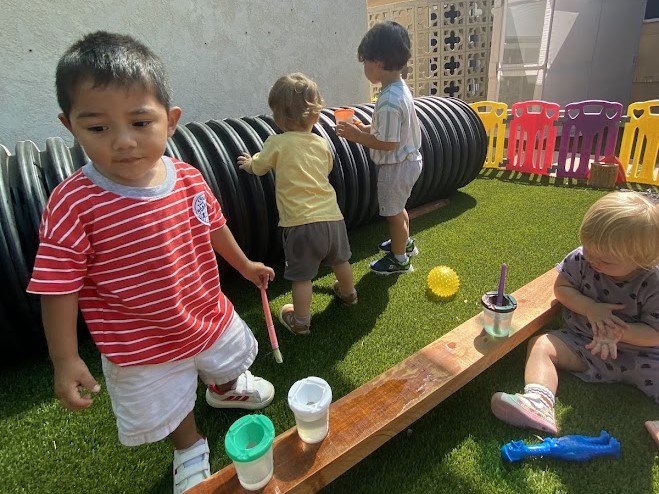 Children exploring water play outdoors